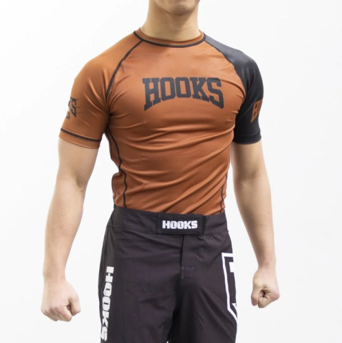 A BJJ rash guard is a type of athletic shirt that is specifically designed for Brazilian Jiu-Jitsu (BJJ) practitioners. It is made of a stretchy, breathable, and moisture-wicking fabric that is comfortable to wear during training or competition. The primary purpose of a BJJ rash guard is to protect the skin from mat burns, cuts, and scrapes that can occur during grappling. It can also help to prevent the spread of bacteria and other germs that can cause skin infections. BJJ rash guards are usually worn under the BJJ gi or on their own during no-gi training. They come in a variety of colors and designs, including long-sleeve and short-sleeve options. Some rash guards also have compression properties that can help to improve blood flow and reduce muscle fatigue. When choosing a BJJ rash guard, it's important to consider factors such as fit, material quality, durability, and design. If you are searching to discover the best BJJ rash guards available in the market, look no further. Hooks Jiujitsu is the leading seller of Jiu Jitsu rash guards in Australia. Shop our BJJ rashguards now! Visit https://hooksbrand.com/collections/rashguards